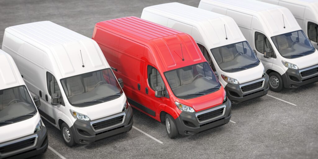 Red delivery van in a row of white vans. Best express delivery and shipemt service concept. fleet trackers fitted nottinghamshire fleet trackers fitted derbyshire fleet trackers fitted leicestershire